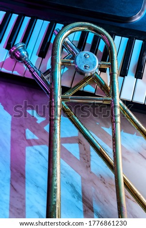 Old and worn Jazz slide trombone and piano keyboard musical show and performance