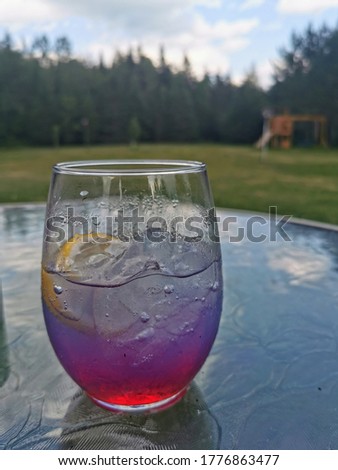 A tasty beverage on an outdoor glass patio table