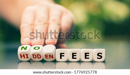 No hidden fees concept. Hand turns dice and changes the expression "hidden fees" to "no fees". Royalty-Free Stock Photo #1776925778