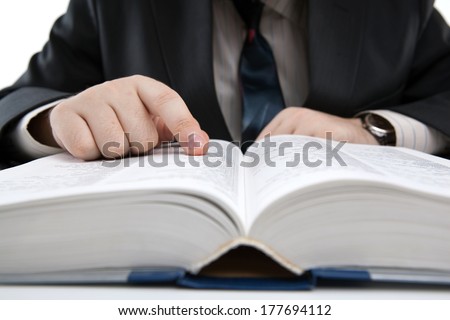 man is looking for information in the dictionary close-up Royalty-Free Stock Photo #177694112