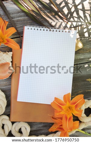 Notebook mock up with lily flowers, outdoor summer photo with palm shadows