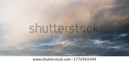 Rainbow in the cloudy rainy sky