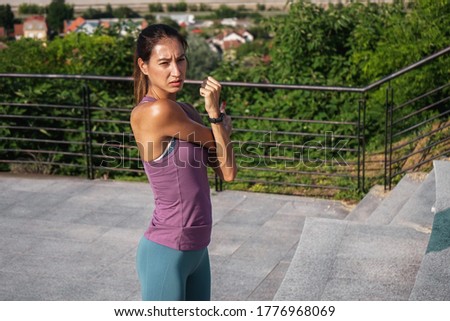 Young woman exercising at sunset