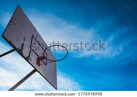 Basketball basket on a summer day with blue sky
