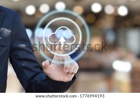 Businessman hand pressing cloud upload icon on virtual touchscreen interface. copy space.
