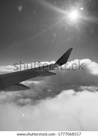 Black and white picture taken from the seat of an airplane. 