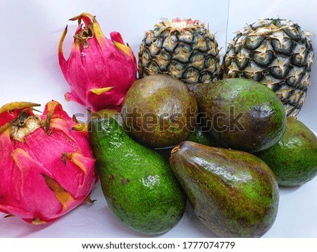 A picture of superfood to mankind in a group. They are pineapples, dragon fruits and avocados.