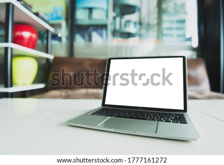 A laptop with a blank screen on the desk in the house
