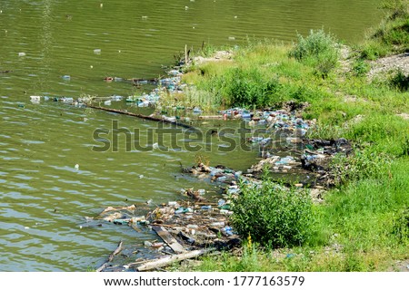 Pollution of water with waste plastics garbage in Lake Izvor Muntelui in Romania. Plastic and Trash Pollution. Royalty-Free Stock Photo #1777163579