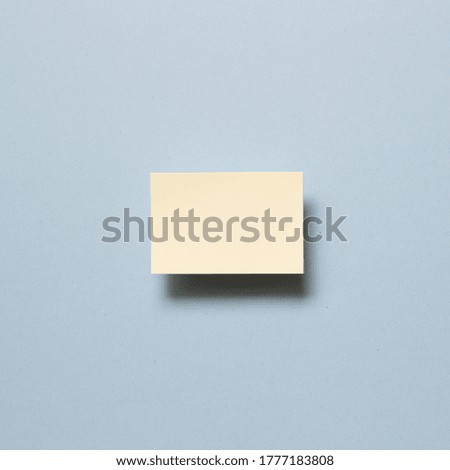 Yellow memo paper, sticky notes on blue background. top view, copy space