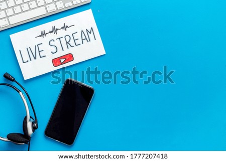 Online streaming social media concept. Paper tablet on office desk top view