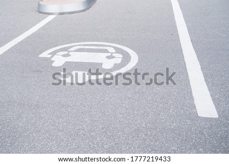 sign on the pavement charging for electric vehicles