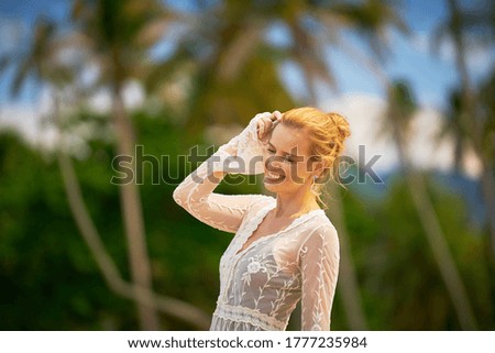 Beautiful woman enjoying the beach and sun in the tropics