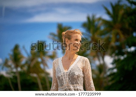 Beautiful woman enjoying the beach and sun in the tropics