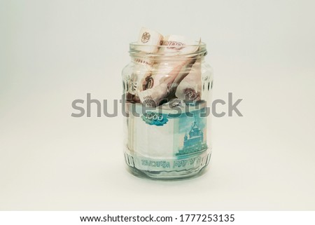 The glass jar is completely clogged with Russian money