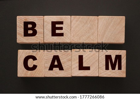 Keep Calm words on wooden cubes on black background. Keep calm reduce stress social lifestyle new normal concept.