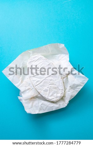 cheese on paper on blue background