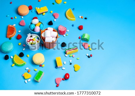 a top view colorful candies different multicolored candies and cookies on the blue background candy sweet confectionery
