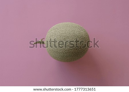 honeydew melon isolated on pink background