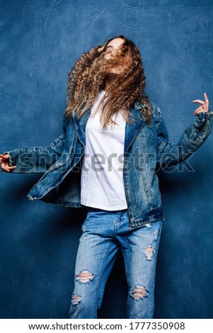 young pretty blond curly girl posing happy smiling on blue background, lifestyle people concept