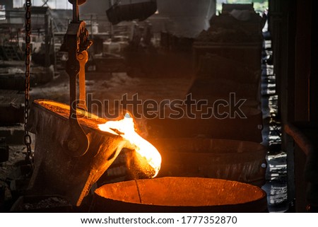 Tank pours liquid metal at the steel mill Royalty-Free Stock Photo #1777352870