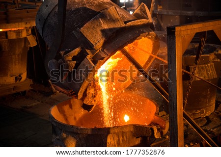 Tank pours liquid metal at the steel mill Royalty-Free Stock Photo #1777352876