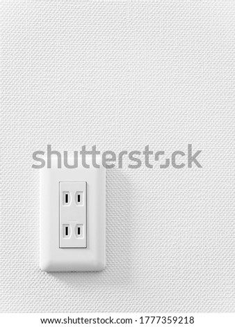 An outlet on a white wall. A Japanese style outlet.