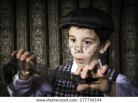 Child considered analog photographic film. Vintage clothes and background
