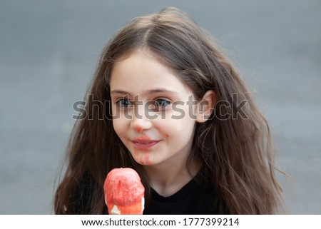 Portrait of a little girl who eating big ice cream