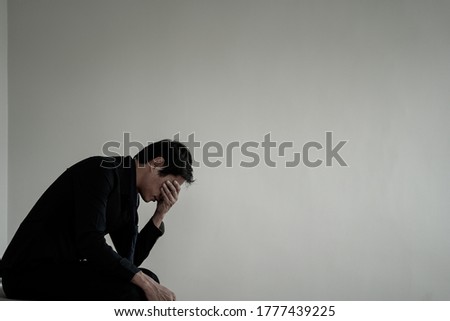 Men sit stressed with problems inside the room. A man is sad and disappointed is lonely. Loneliness and disappointment with life Royalty-Free Stock Photo #1777439225