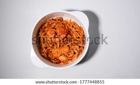 Mie Tarempa, as known as Tarempa Noodle, is a traditional food from Anambas, Indonesia. It's a noodle with a sweet and sour spice and seafood topping on it. (Tilted bowl and Top view)