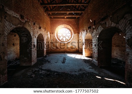 Round stained glass window in old abandoned castle Royalty-Free Stock Photo #1777507502