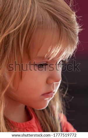 image of a child from the profile while she is playing the game, note shallow depth of field