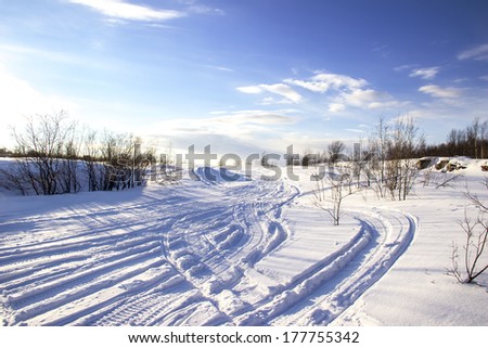 footprints on the snow machines Royalty-Free Stock Photo #177755342
