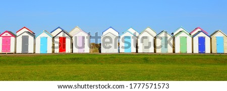 Row of beach huts in coastal town of Paignton, Devon