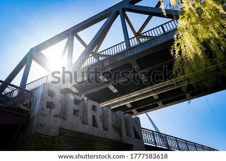 berlin entering sign under a bridge