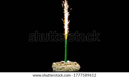 Holiday cake with fireworks on a black background