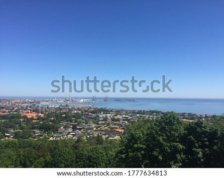 Frederikshavn. A landscape picture of The Harbor City and The ocean accompanied by a blue sky.