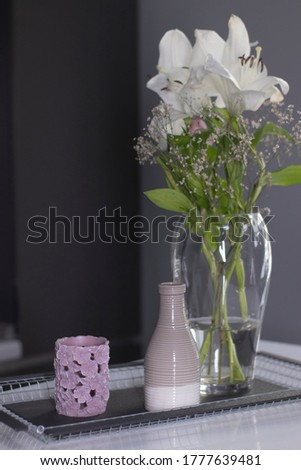 set of home decoration - candle, vase and flowers - on a handmade black metal tray at the kitchen. home interior and decor concept. High quality photo