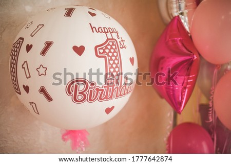 White-pink air helium balloons in honor of the child's birthday. decoration of a children's party for a girl