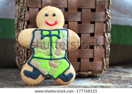 Homemade Gingerbread men in protective khaki uniforms on Defender of the Fatherland Day, close up