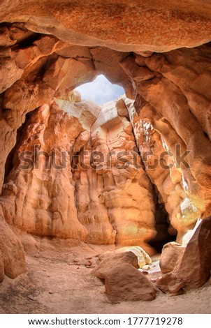 The mountain cave has an opening above the sunlight