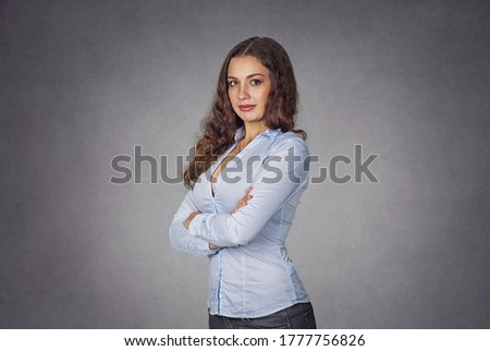 Success. Closeup portrait confident beautiful happy young woman arms crossed, hands folded, smiling isolated gray background wall. Positive human emotion face expression life perception  attitude