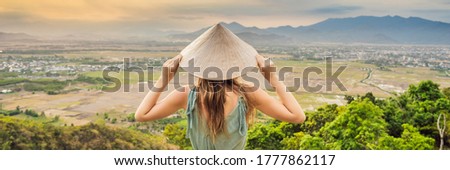 Young woman tourist in a traditional Vietnamese hat travels to Vietnam BANNER, LONG FORMAT