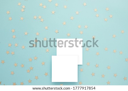 Empty card and gold confetti on blue background. Mockup template. top view