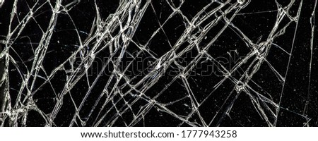 white cracks on a black glass surface, abstract, texture