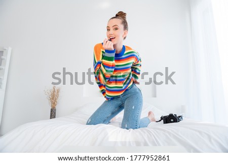 Photo of young pretty lady talk video call shooting self selfies pictures posing camera playful millennial applying pomade lips ready for online date casual outfit sheets bedroom indoors