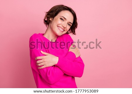 Photo of overjoyed charming lady touch hands hug herself shoulders joyful soft cloth laundry warmth toothy smiling wear casual bright sweater isolated pink pastel color background Royalty-Free Stock Photo #1777953089