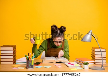 Portrait of her she attractive focused knowledgeable brainy diligent woman nerd reading book finding solution drinking caffeine isolated bright vivid shine vibrant yellow color background Royalty-Free Stock Photo #1777955267