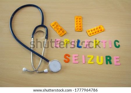 word with colorful epileptic seizure letters on a table with a stethoscope and medicines
